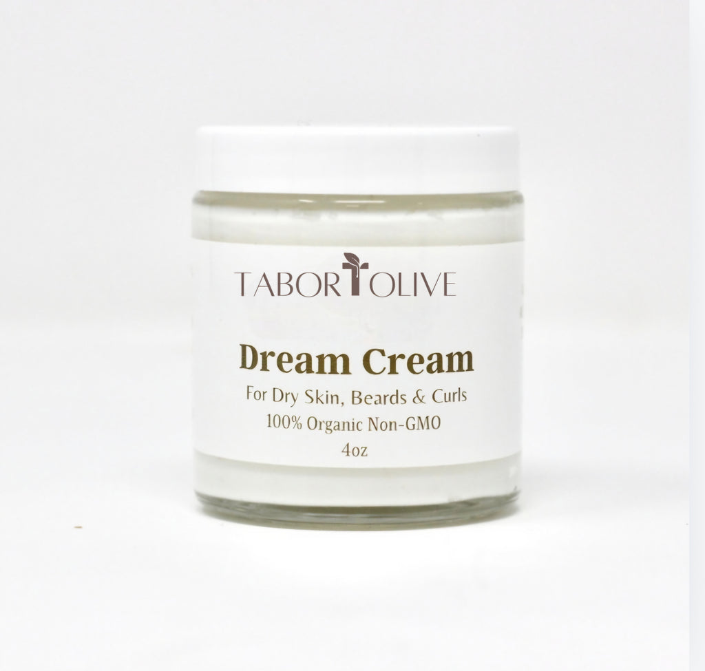 Clear jar with white lid that says, "Dream Cream. Fpr dry slin, beards and curls. Organic Non-Gmo"