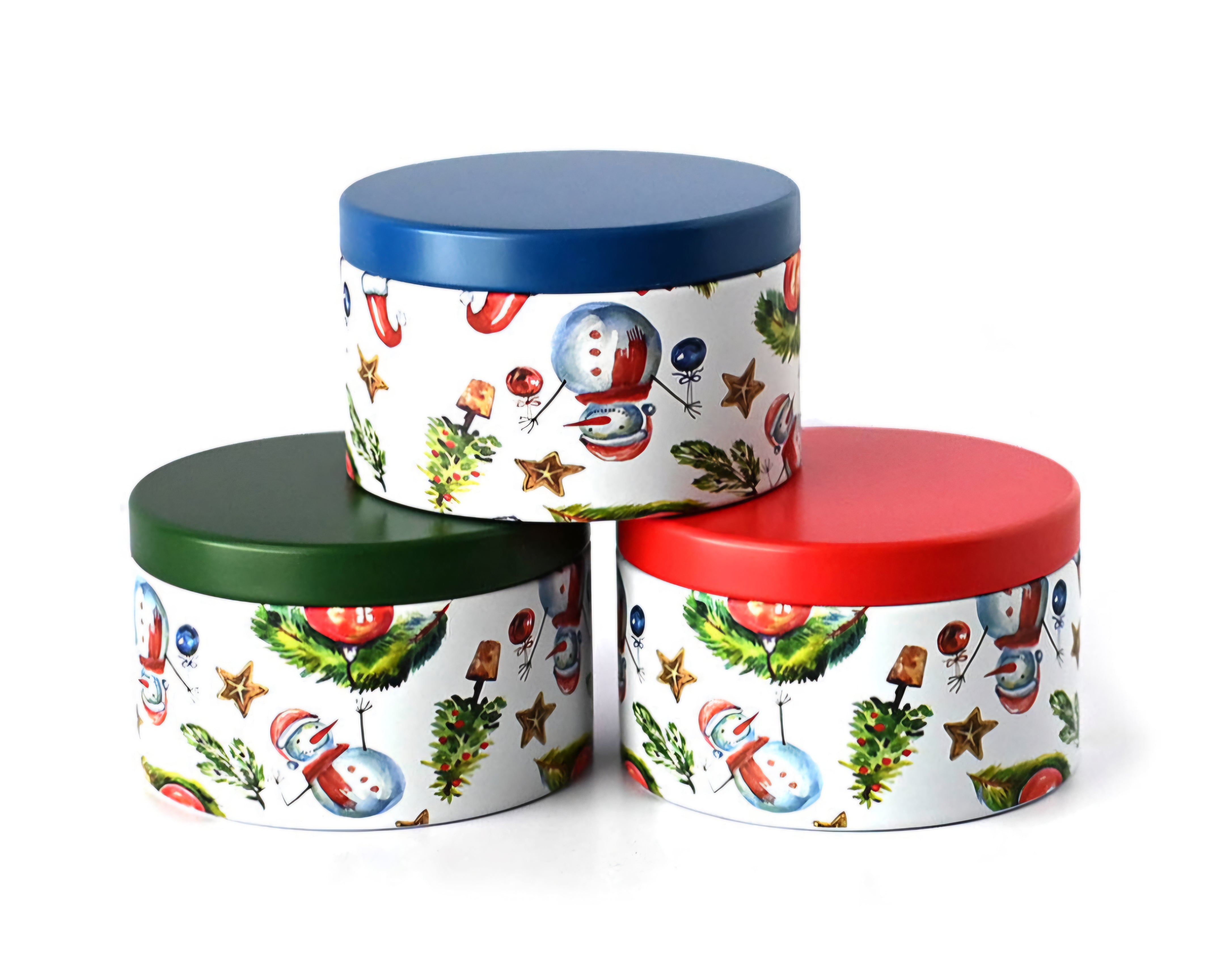 Three holiday print candle tins eith res green and blue lids with snowmen, Christmas trees and ornaments.